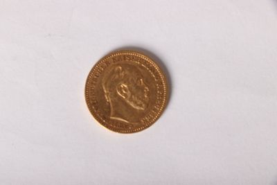 une pièce d'or sur laquelle figure l'image d'un homme
