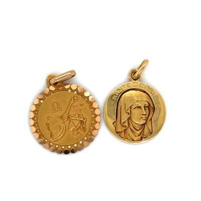 two gold - plated medallions of a woman and a man