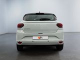 the rear end of a white car parked in a white room