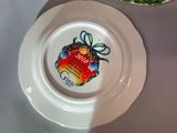 a white plate with a label on it next to a bowl of broccoli