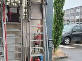a fire hydrant and ladders in front of a building