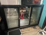 a small refrigerator with two doors open in a room