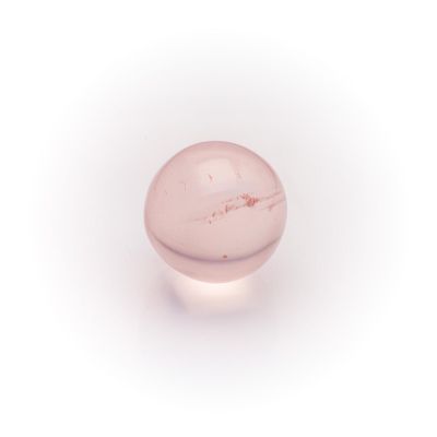 an image of a pink glass ball on a white surface