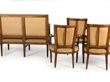 several chairs and a table are arranged in a row on a white surface