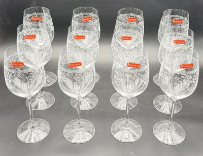 six clear wine glasses are lined up in a row on a table