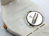 a white watch that is sitting on a white surface