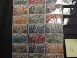 a lot of stamps that are on a black table
