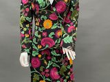 a mannequin wearing a black and pink floral print dress