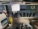 a picture of a cluttered kitchen with a lot of clutter on the counter