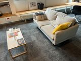 a living room with a couch, coffee table, and bookshelf