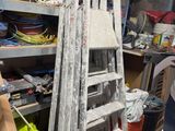 a man that is standing next to a ladder