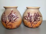 two vases that are sitting on a table