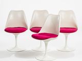 three white tulip chairs with pink cushions on a white surface