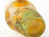 underside view of a glass vase with a yellow and green design on it
