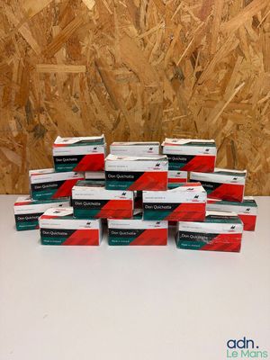 several boxes of cigarettes sitting on top of a table in front of a wooden wall