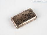 a silver cigarette case with a picture of a woman on it