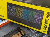 a box with a keyboard on top of a pile of books