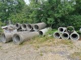 a pile of pipes sitting in the middle of a field