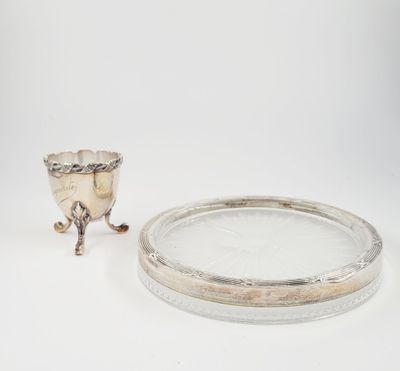 an antique silver plate with a silver cup on it and a silver plate with a silver cup on it