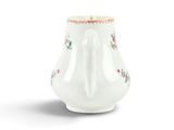 a small white vase with a floral design on it