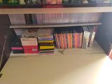a white desk with a bunch of dvds on it
