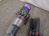 two vacuums that are on the floor next to each other