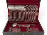 silverware in a wooden box with red velvet lining