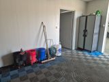 a room that has a bunch of trash cans and a rack in it