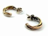 two tone gold and silver hoop earrings on a white background