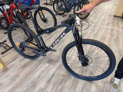 a man standing next to a bicycle in a store