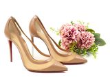 pair of women ' s high heeled shoes and a bouquet of flowers