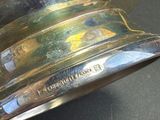 a close up of a silver bell on a table