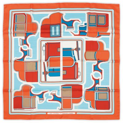 a close up of an orange and blue square scarf on a white background