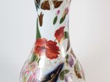a white vase with a floral design on it