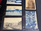 a collection of old photographs on display on a table