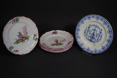 three plates with designs of birds and flowers on them on a black surface
