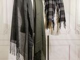 two scarves on a mannequin stand in a room