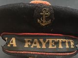 a black hat with a gold anchor on it