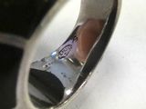 a black and silver ring with a picture in it