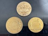 three different types of gold coins sitting on top of a table