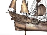 a wooden model of a ship on a stand