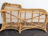 a wicker couch that is sitting on the floor