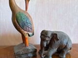 statue of a bird and an elephant on a wooden table