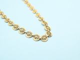 a gold necklace on a blue background