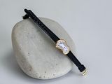 an image of a wrist watch sitting on top of a stone