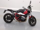 a red and black motorcycle parked in a white room