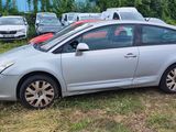 a silver car that is parked in the grass