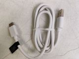 a white cable that is connected to a black and white charger