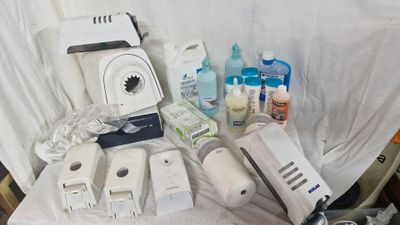 a table with a bunch of items that include a blender, a bottle of water, a toothbrush, a toothpaste and a toothbrush