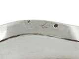 a close up of a silver plate on a white background